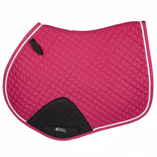 A magenta OEQ jump saddle pad with diamond quilted design, featuring a cordura girth patch, silky piping, and a branded label on the underside.