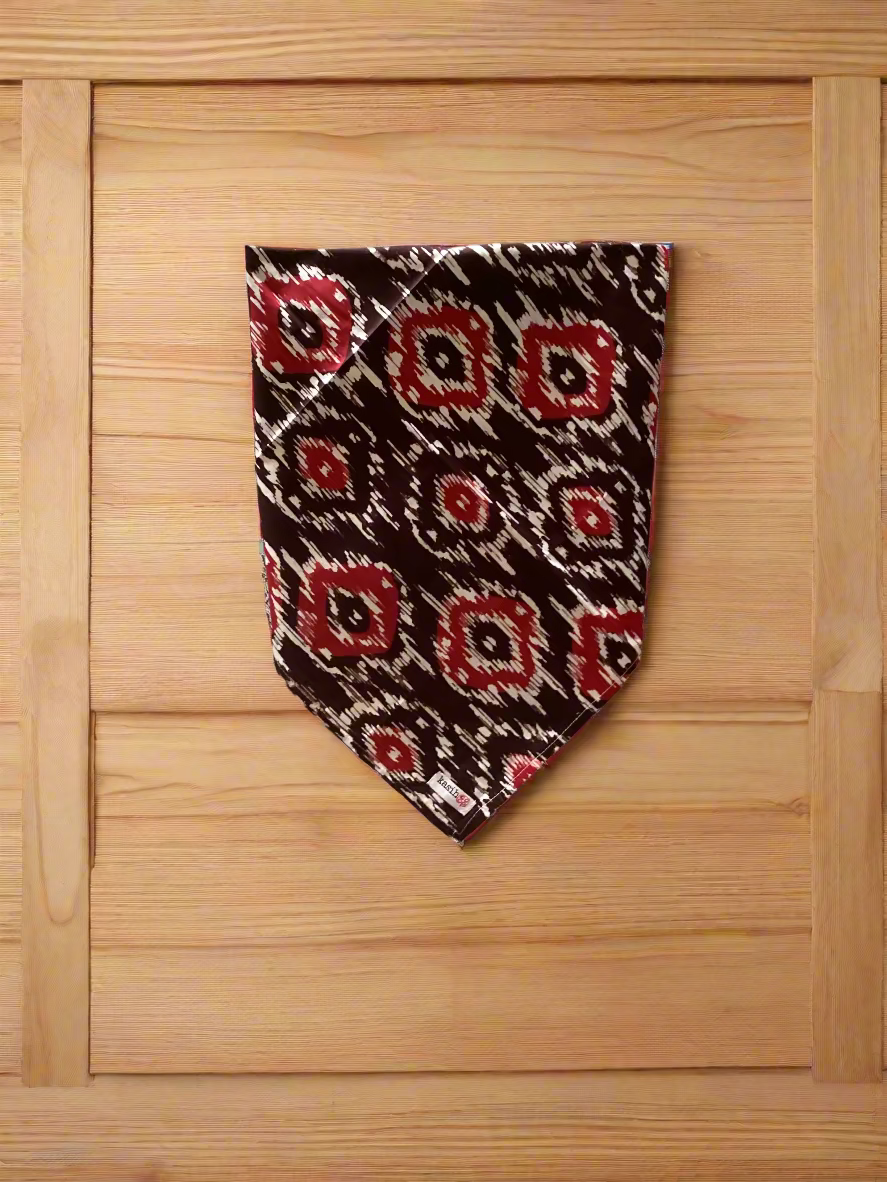 Patterned tie hanging against a wood background