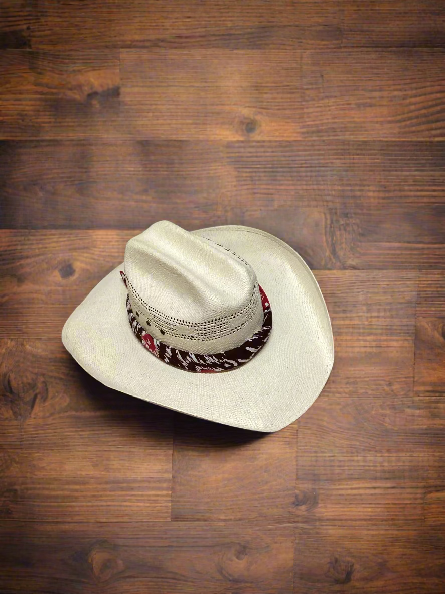 Cowboy hat with a colorful band on a wooden surface