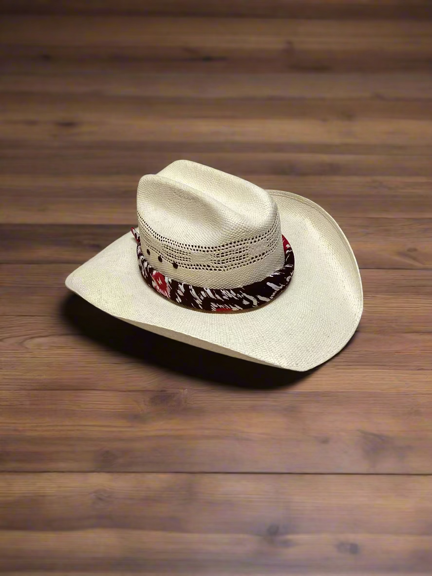 Cowboy hat with a decorative band on a wooden surface