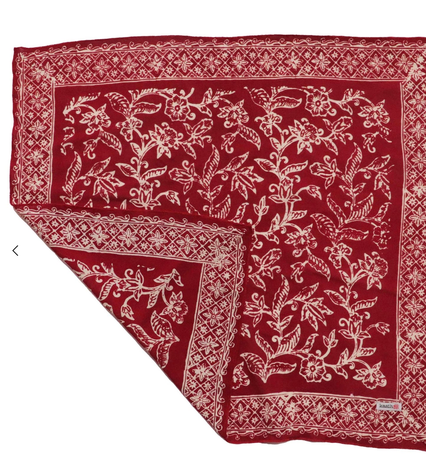 Red fabric with white floral patterns on a white background