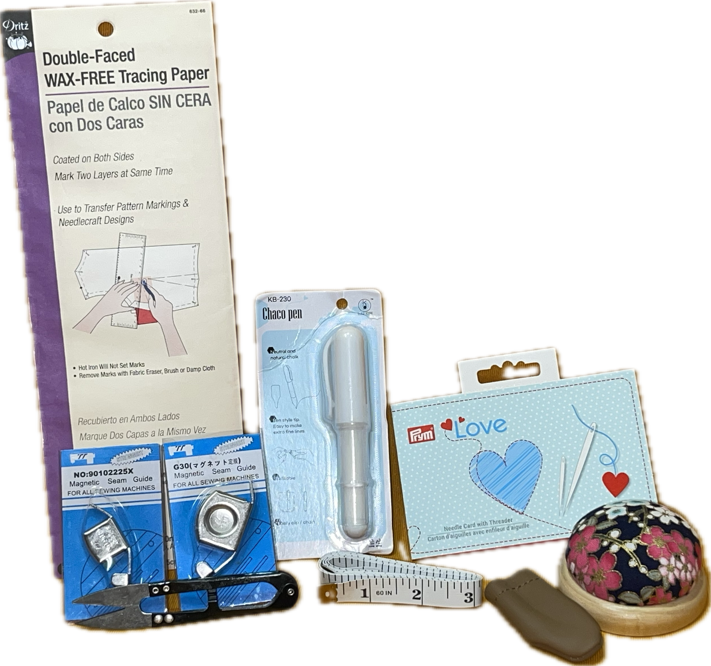 sewing kit tracing paper tape measure pin cushion leather thimble needles snips chalk pen seam guide
