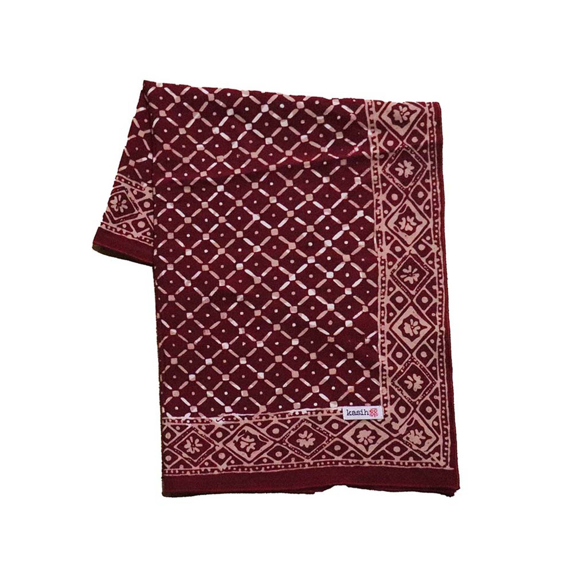 Maroon and beige patterned fabric on a white background