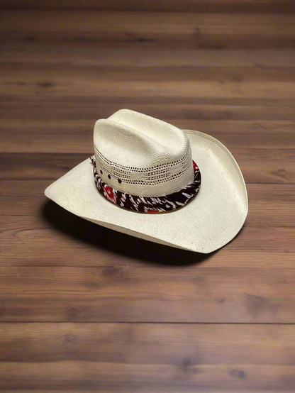 Cowboy hat with a decorative band on a wooden surface