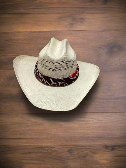 Beige cowboy hat with a colorful band on a wooden surface