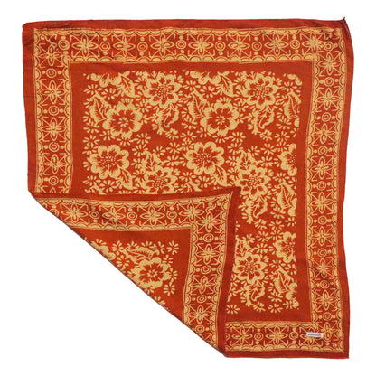Red scarf with gold floral pattern on a white background
