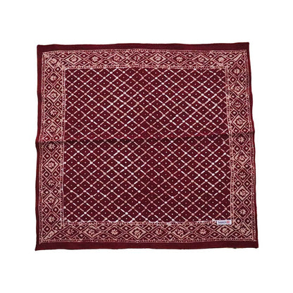 Maroon fabric with diamond pattern on a white background