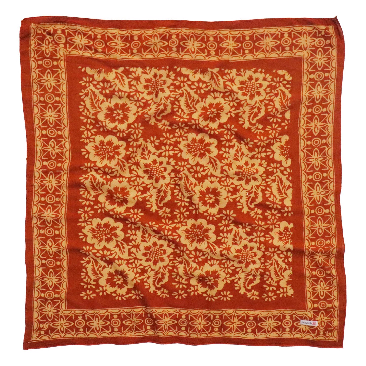 Red fabric with beige floral pattern on a white background