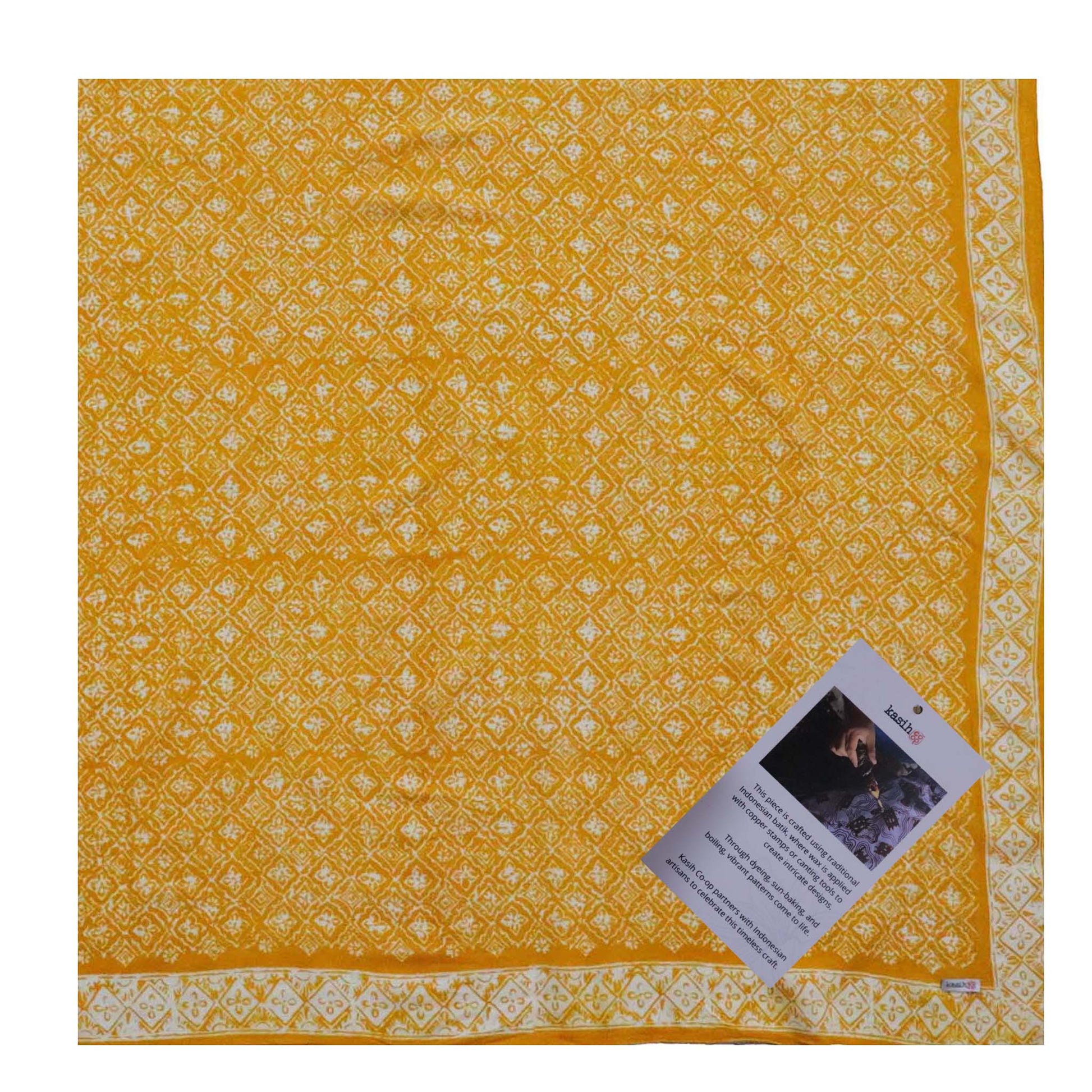 Yellow fabric with white pattern and a tag on a white background